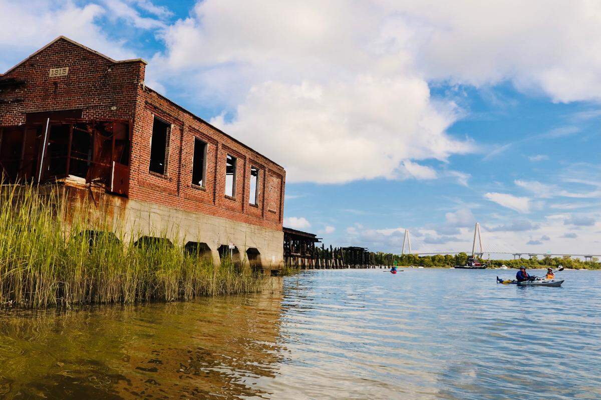 The Charleston Coal Tipple ruins can be experienced by boat and provide a unique view of the industrial history of Charleston. Here, kayakers Tim Brown and Steve Houghtaling of Savannah and George Hancock of Beaufort inspect the site from a respectful distance.