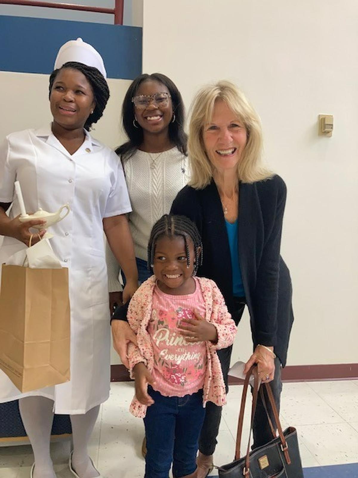 Sharonda Jenkins after the Pinning Ceremony with daughter Sha’mya, granddaughter Lyric, and family friend and Sha’mya’s former volunteer tutor, Nona Valiunas of Spring Island.