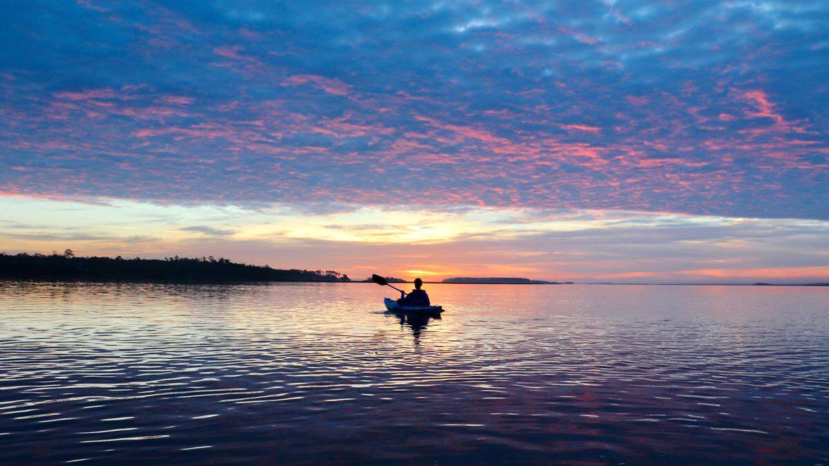 Kayaker Alan Eisenman of Beaufort paddles into the sunrise on the beautiful and scenic Chechessee. A popular and well-maintained boat landing on S.C. 170 makes this stretch of Port Royal Sound highly accessible by boat or kayak.