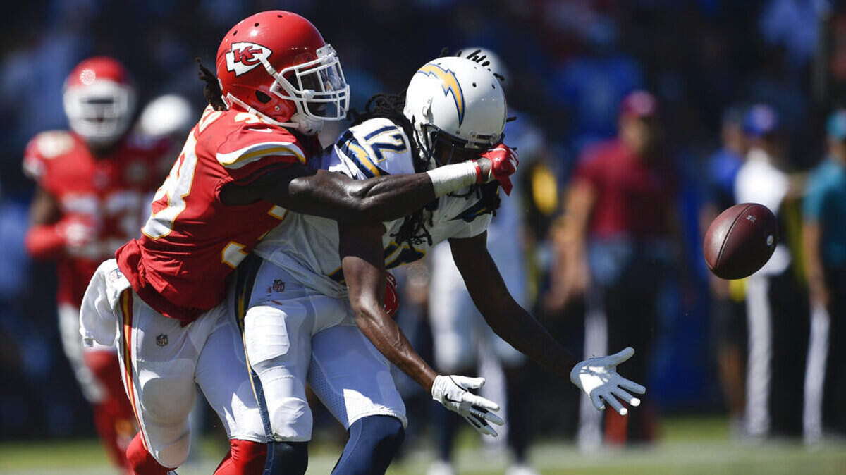 Los Angeles Chargers wide receiver Travis Benjamin, right, drops a pass under pressure form Kansas City Chiefs defensive back Ron Parker during the first half of an NFL football game Sunday, Sept. 9, 2018, in Carson, Calif.