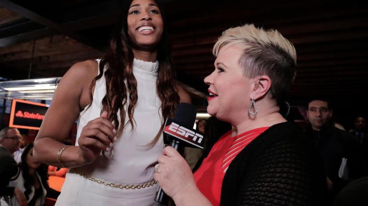 Alaina Coates, left, reacts during an interview after being selected as the No. 2 pick in the WNBA basketball draft by the Chicago Sky