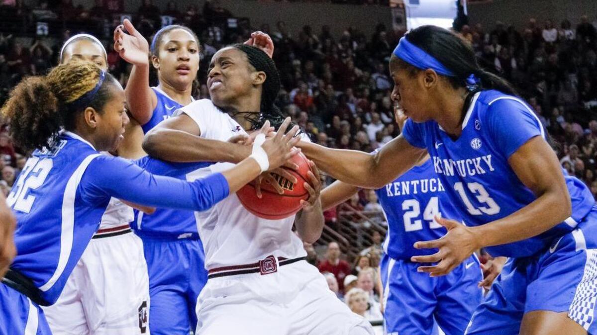 South Carolina’s Doniyah Cliney grapples for the ball between Kentucky’s Jaida Roper (32) and Evelyn Akhator.