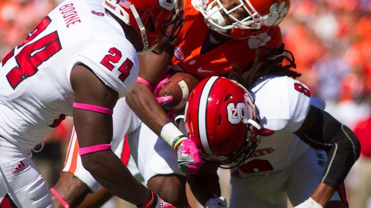 Clemson Tigers running back Wayne Gallman (9) fumbles the ball while being brought down by North Carolina State Wolfpack defensive back Dravious Wright (8)