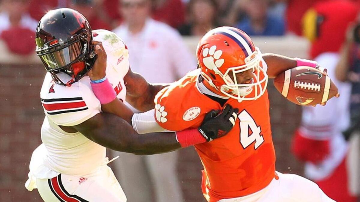 Clemson quarterback Deshaun Watson is pursued by Louisville’s James Sample during an October game in Clemson.