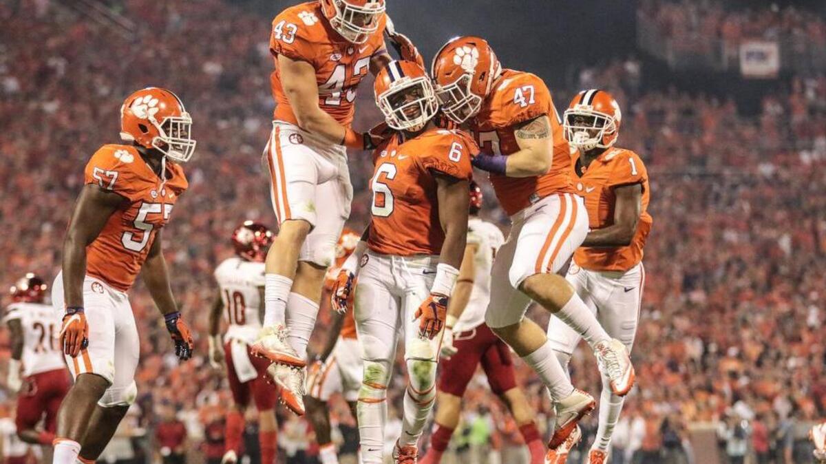 Clemson defenders Chad Smith, Dorian O'Daniel and James Skalski celebrate a sack in the second quarter of Louisville quaterback Lamar Jackson.