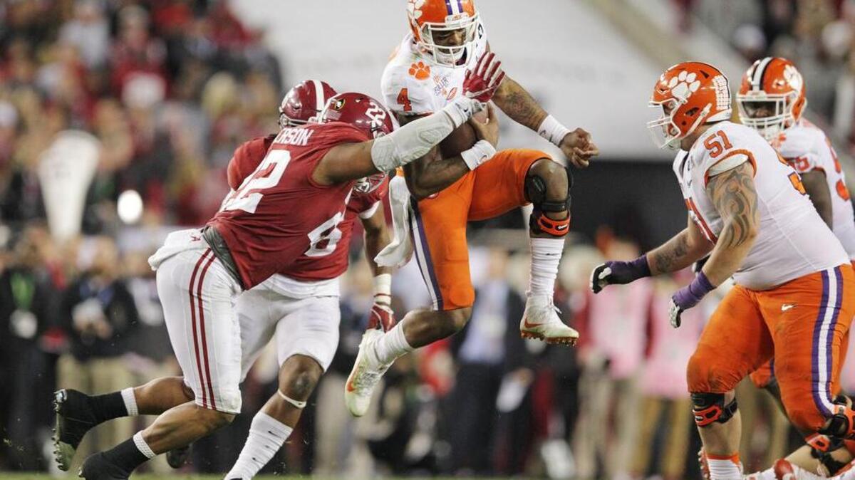Clemson Tigers quarterback Deshaun Watson (4) leaps for extra yards in the second half of the National Championship Game.