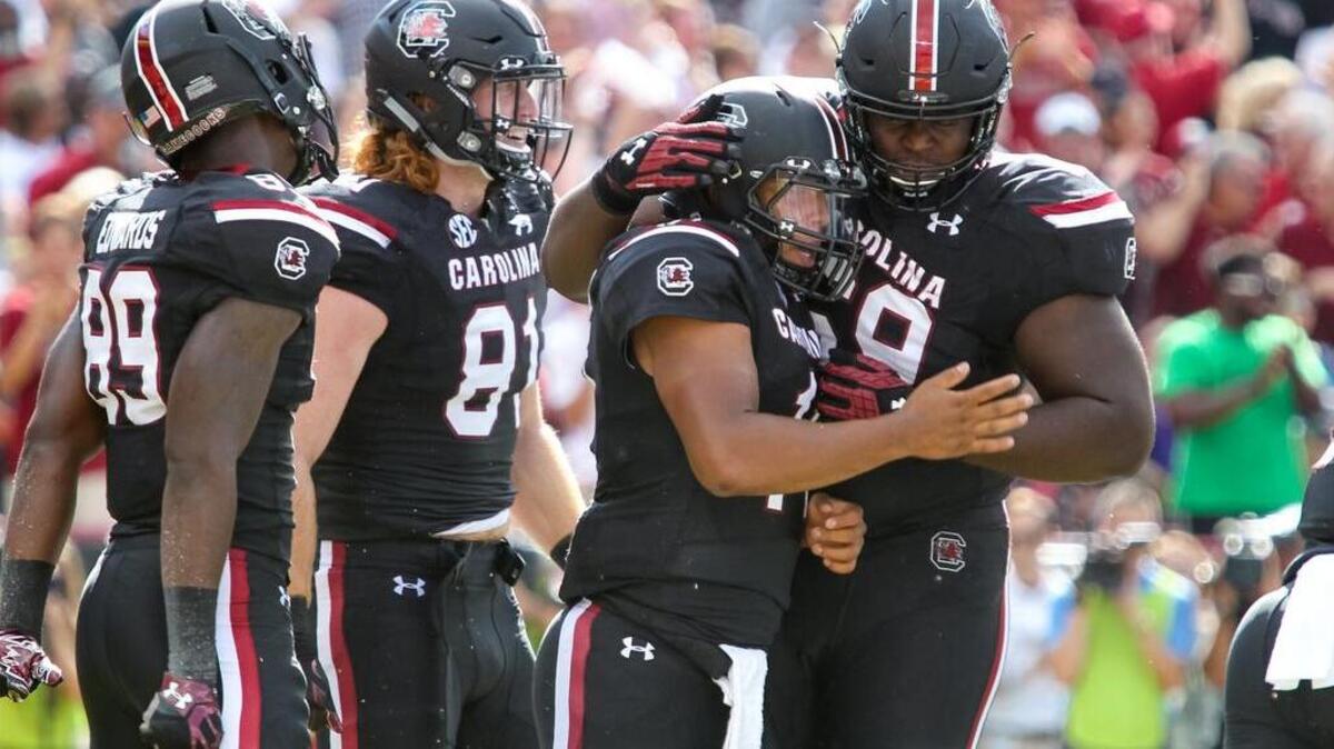 South Carolina quarterback Brandon McIlwain (11) is congratulated for a touchdown by his teammates during the first half of the game against East Carolina.