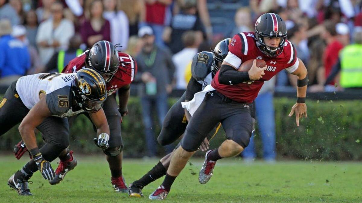 South Carolina Gamecocks quarterback Jake Bentley (4) looks for space on a keeper in the first half of their game against Missouri at Williams-Brice Stadium.