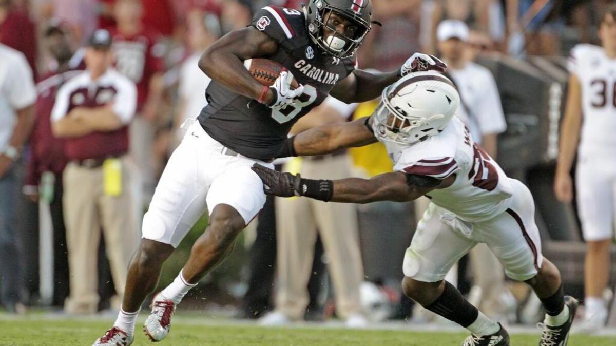 South Carolina Gamecocks tight end K.C. Crosby (3) tries to break free from Texas A&M Aggies defensive back Armani Watts (23) on Saturday.