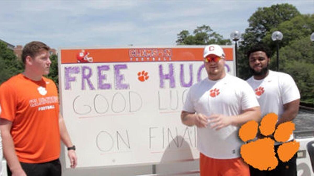 Clemson football players delivered hugs, lollipops and good wishes to students during finals week on the Clemson University campus.