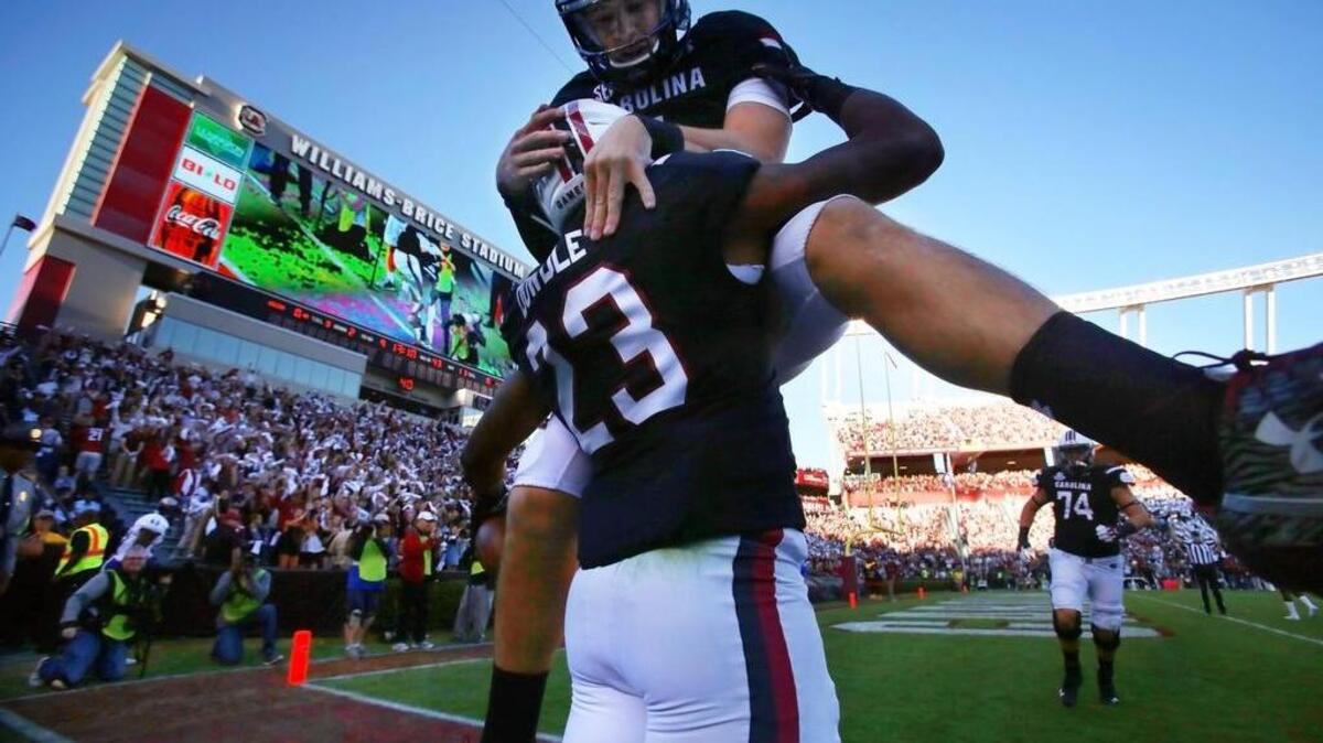 South Carolina Gamecocks running back Rico Dowdle (23) celebrates his touchdown with quarterback Jake Bentley (4) in the first half at Williams-Brice Stadium, Saturday.