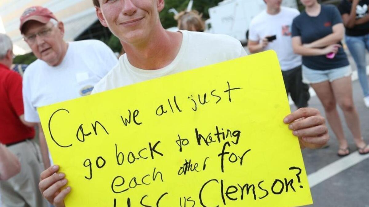 David Cadieu brought a new sign on the Statehouse grounds on the last day the Confederate flag will fly on Statehouse grounds. It reads: “Can we all just go back to hating each other for USC vs. Clemson?” 7/9/15