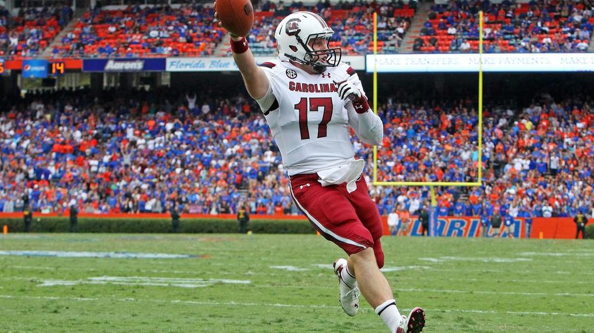 In 2014, South Carolina quarterback Dylan Thompson (17) scores the winning touchdown on a keeper in overtime against Florida at Ben Hill Griffin Stadium.