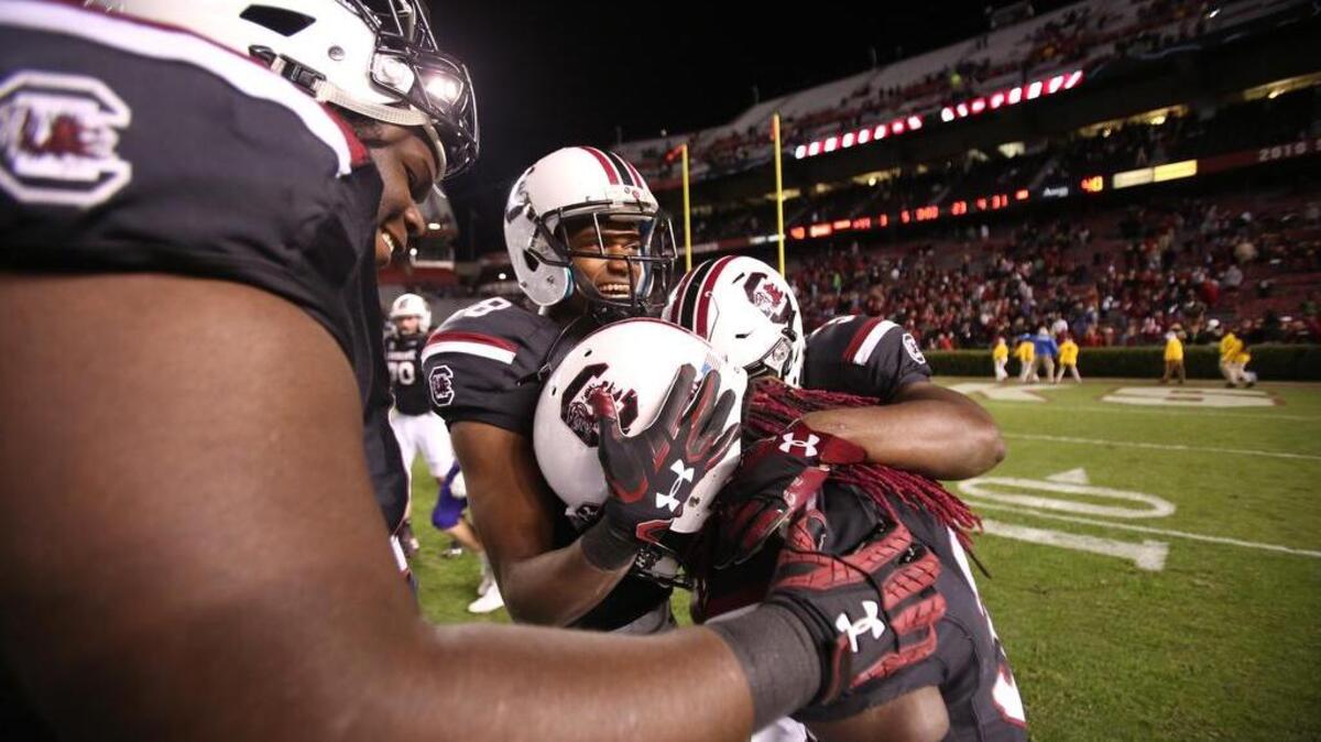 South Carolina Gamecocks running back Darius Paulk (30) is congratulated by teammates after his run on the final play of the game against Western Carolina at