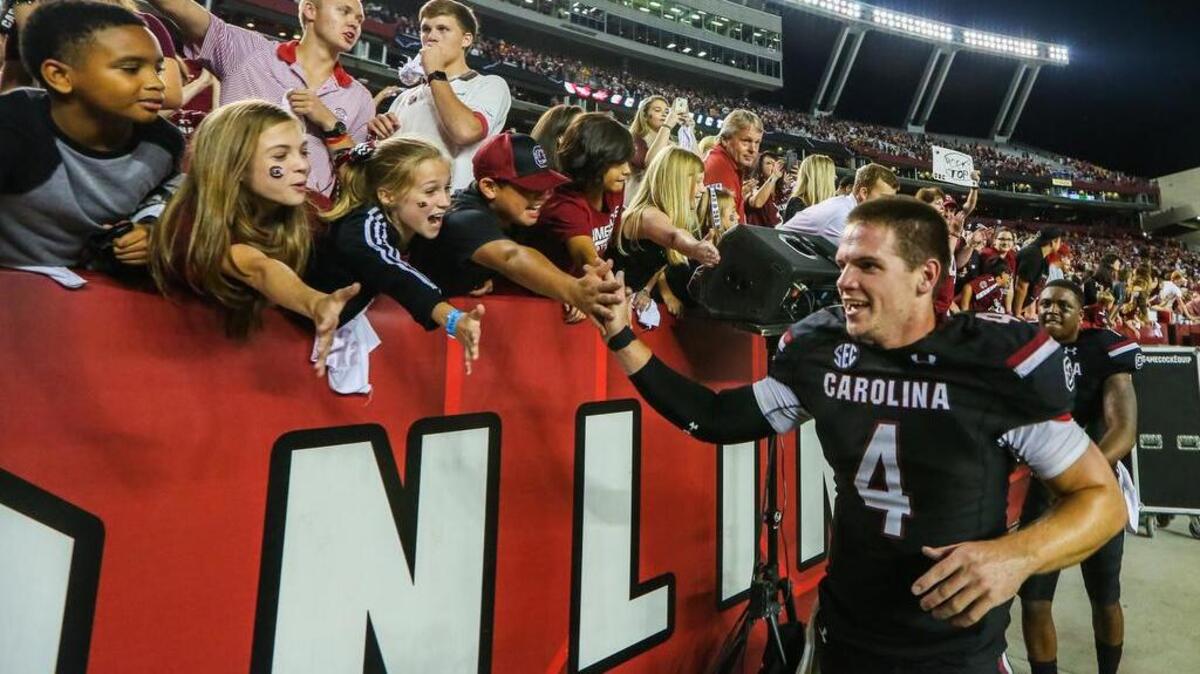 South Carolina quarterback Jake Bentley (4) celebrates the 24-21 win over Tennessee with fans at Williams-Brice Stadium on Saturday.