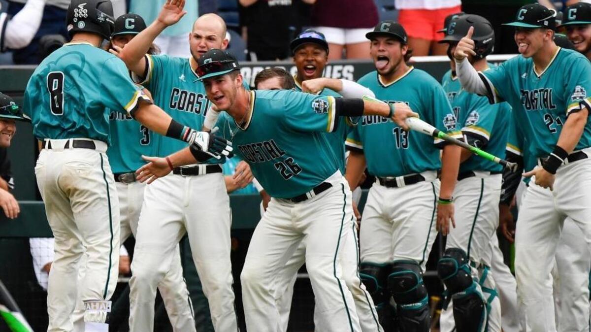 Coastal Carolina’s Tyler Chadwick (8) is greeted at the dugout by teammates after hitting a solo home run during the second inning of the Chants’ 7-5 win over TCU on Saturday night.