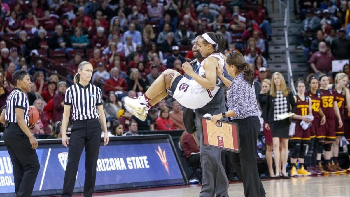 Freddy Ready carries South Carolina's Allisha Gray (10) off the court during the second half of action in the Colonial Life Arena.