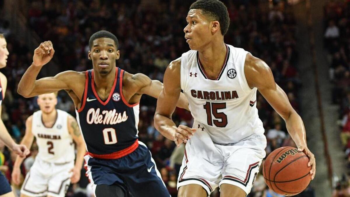 USC's PJ Dozier looks for an open teammate as Ole Miss Donte Fitzpatrick-Dorsey applies defensive pressure during their game Saturday.