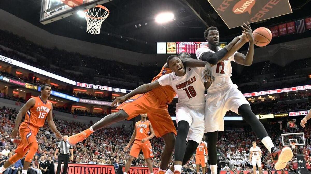 Louisville's Jaylen Johnson (10) and Mangok Mathiang (12) battle Clemson's Sidy Djitte (50) for the ball during the second half Thursday. Louisville won 92-60.