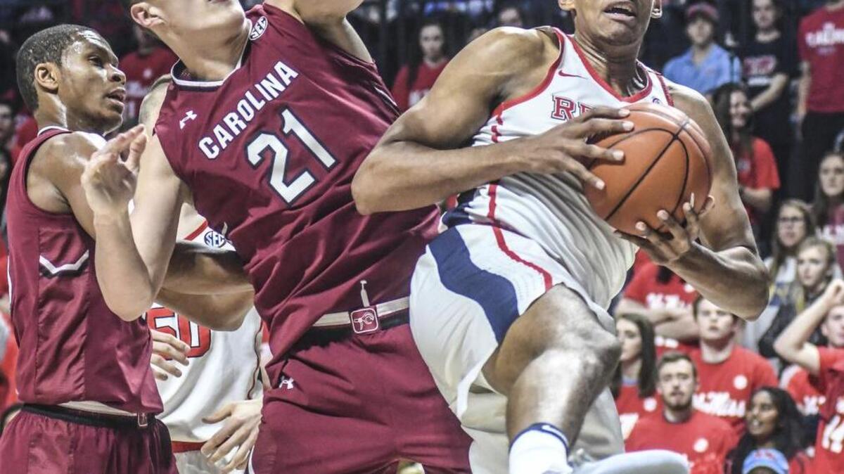 Ole Miss forward Sebastian Saiz grabs a rebound in front of South Carolina forward Maik Kotsar.