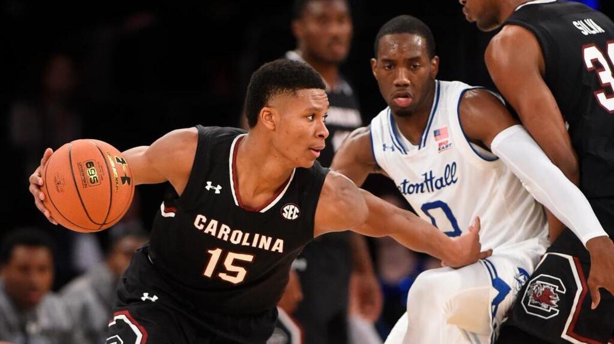 South Carolina’s PJ Dozier drives around Seton Hall’s Khadeen Carrington in the first half Monday.