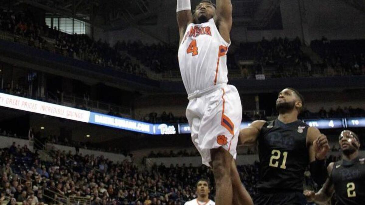 Clemson guard Shelton Mitchell dunks ahead of Pittsburgh’s Sheldon Jeter for two of his 12 points in the Tigers’ 67-60 win.