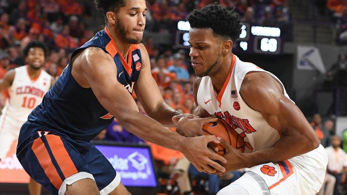 Virginia forward Isaiah Wilkins, left, fights for the ball with Clemson forward Jaron Blossomgame (5) during their game Saturday at Littlejohn Coliseum.
