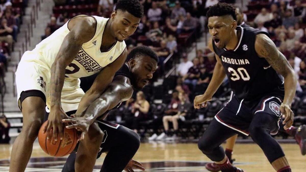 Mississippi State’s Eli Wright (2) battles for a rebound away with South Carolina’s Duane Notice (10) and Chris Silva (30) on Saturday in Starkville, Miss.
