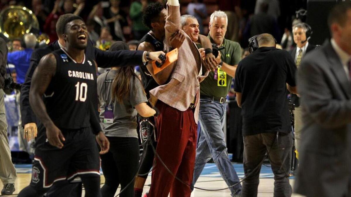 South Carolina Gamecocks guard Duane Notice (10) forward Chris Silva (30) and head coach Frank Martin celebrate their win over Duke at Bon Secours Wellness Arena in Greenville.