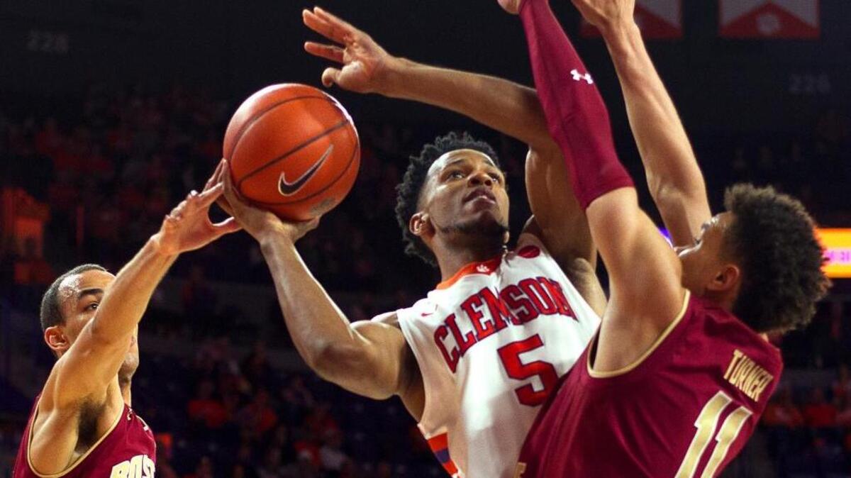 Clemson’s Jaron Blossomgame attempts to go to the basket against Boston College’s Jordan Chatman, left, and A.J. Turner during the second half at Littlejohn Coliseum on Saturday.