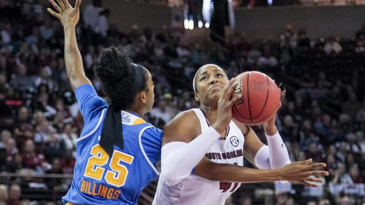 Alaina Coates shoots as Monique Billings defends.