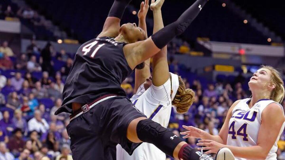 South Carolina center Alaina Coates puts the ball up as LSU forwards Alexis Hyder and Tatum Neubert (44) defend Sunday.