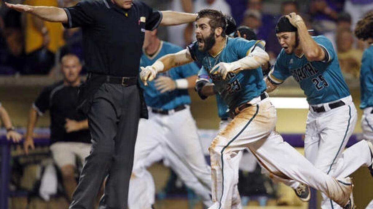 Coastal Carolina's Anthony Marks (29) reacts after sliding into home plate to score the winning run in the bottom of the ninth inning of an NCAA college baseball tournament super regional game against LSU in Baton Rouge, La., Sunday, June 12, 2016. Coastal Carolina won to advance to the College World Series.