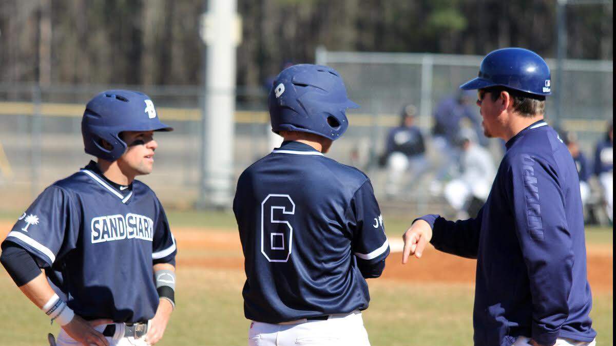 USC Beaufort assistant baseball coach Pat Cottrell chats with players Josh Reinhart and John Cloyd.