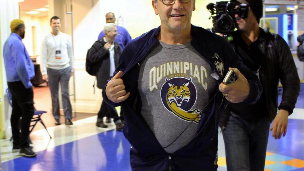 UConn coach Geno Auriemma displays a Quinnipiac University T-shirt before his team's Sweet 16 NCAA women's college basketball practice in Bridgeport, Ct., Friday, March 24, 2017.