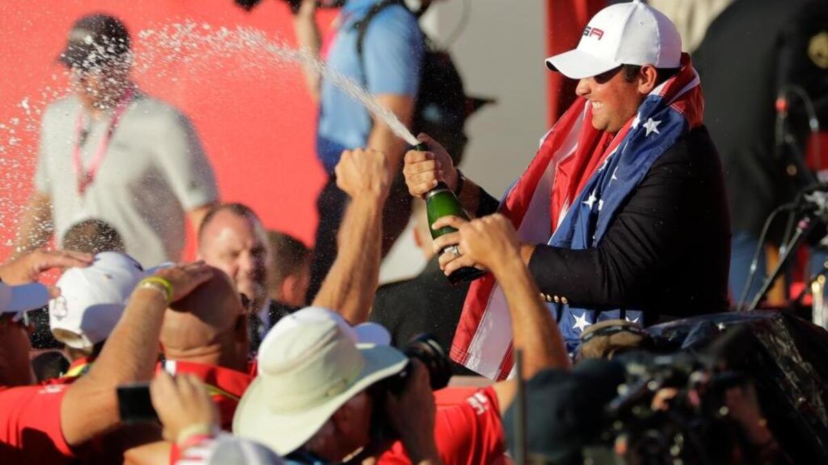 Patrick Reed sprays champagne during Sunday’s closing ceremony of the Ryder Cup, which the Americans reclaimed for the first time since 2008. Reed’s victory over Europe’s Rory McIlroy set the tone for U.S. singles success.
