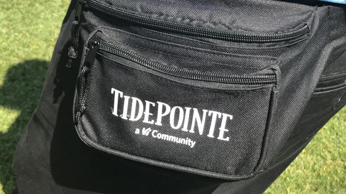 A volunteer at the RBC Heritage Presented by Boeing golf tournament wore a fanny pack distributed by the program at Harbour Town Links on Hilton Head Island on Friday.