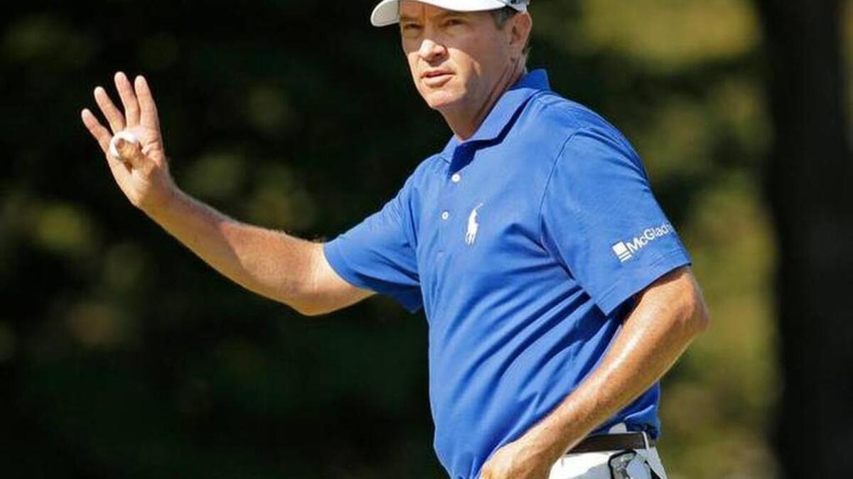 Davis Love III waves to the crowd on the 18th hole during the final round of the Wyndham Championship golf tournament Aug. 23, 2015 at Sedgefield Country Club in Greensboro, N.C. Love won the tournament.