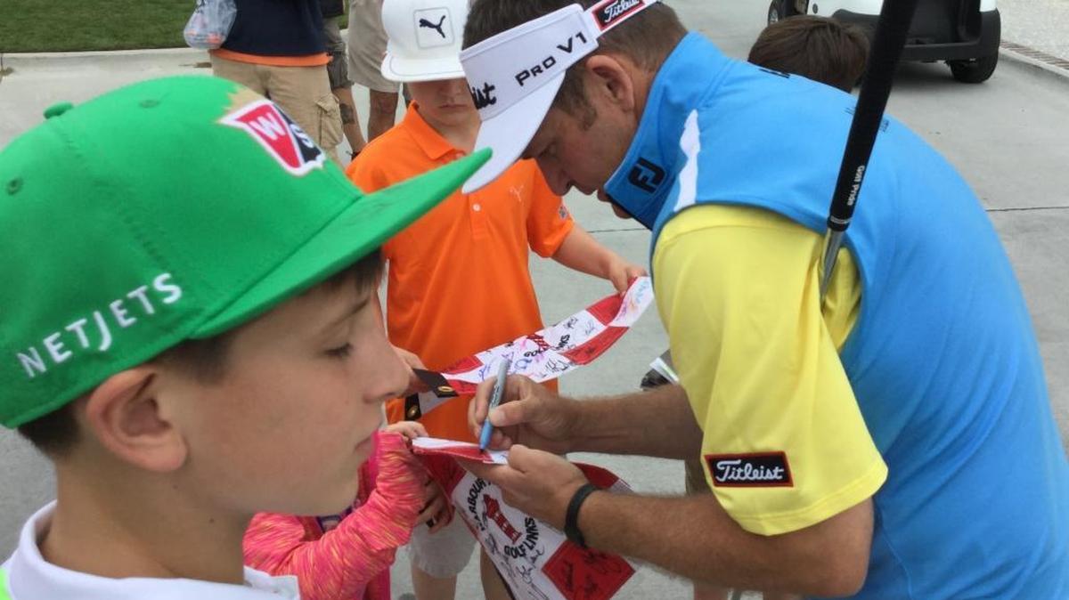 Jason Bohn signs autographs near the putting green at Harbour Town Golf Links after his RBC Heritage practice round Tuesday. Bohn is playing his first PGA Tour event since suffering a heart attack in February.