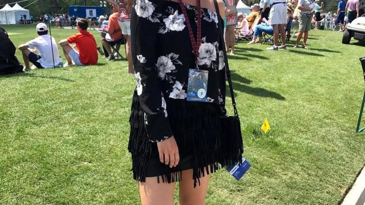 A spectator at RBC Heritage presented by Boeing golf tournament sports a black fringe skirt and purse Thursday afternoon.