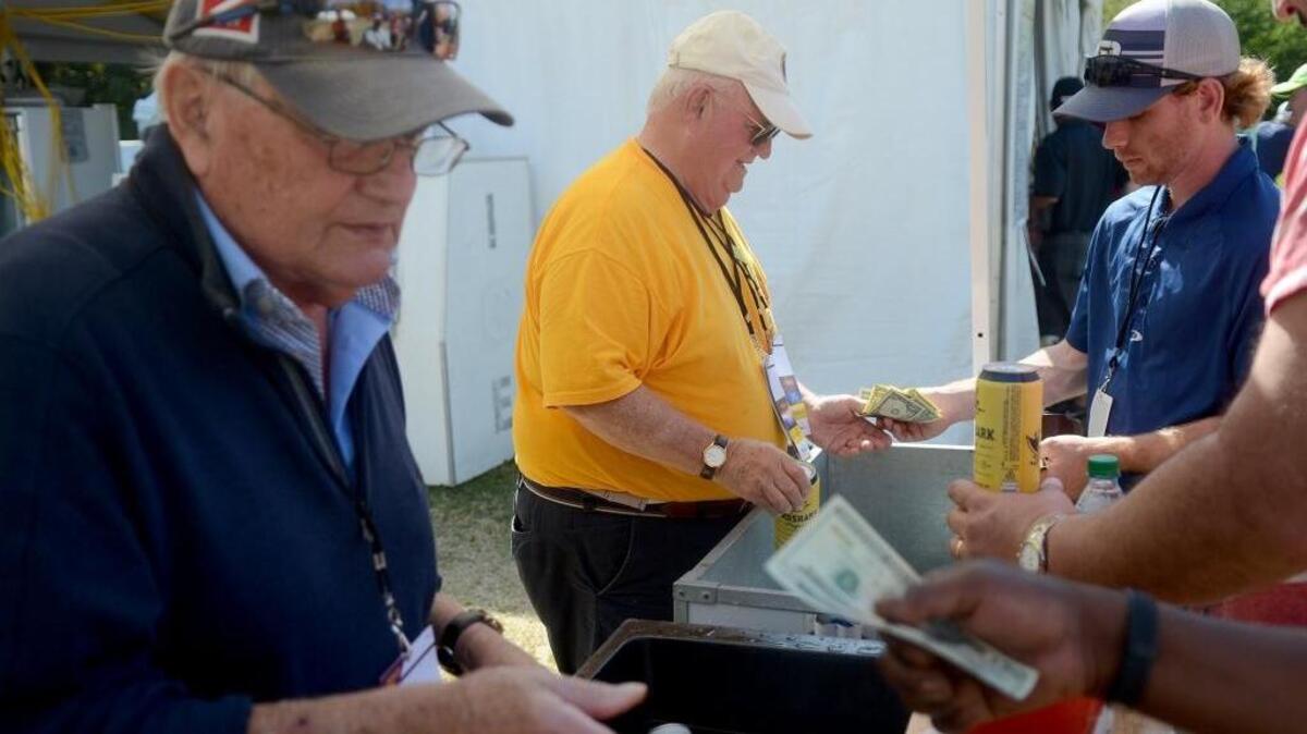 Steve Morse, left, and David Cullen, both of Sun City, serve beer from the Sun City Lions Club booth near No. 13 during the second round of the RBC Heritage on Friday at Harbour Town Golf Links in Sea Pines on Hilton Head Island S.C.