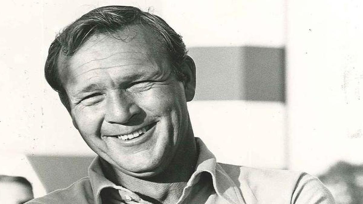 Arnold Palmer stands in front of iconic Harbour Town Lighthouse in this photo.