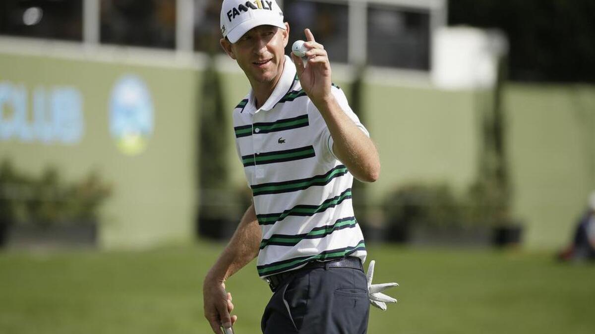 Vaughn Taylor holds up his ball after making a birdie putt on the 15th green of the Pebble Beach Golf Links during the final round of the AT&T Pebble Beach National Pro-Am on Feb. 14 in Pebble Beach, Calif.
