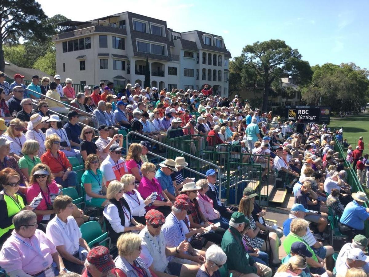 A crowd sits in the sunshine during the 2016 opening ceremony for the RBC Heritage Presented by Boeing golf tournament at the 18th green of the Harbour Town Golf Links on Hilton Head Island.