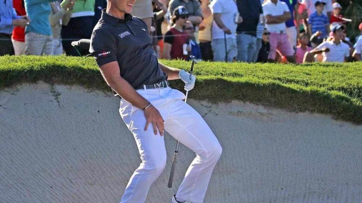 Danny Willett watches as his ball rolls close to the hole after a sand shot to save par on the 13th hole in the final round of the WGC-Cadillac Championship at Trump National Doral on March 6 in Miami.