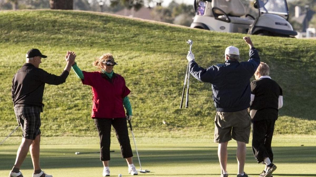 A foursome finishes a round on a high note at Myrtlewood Golf Club’s PineHills Course on Friday.