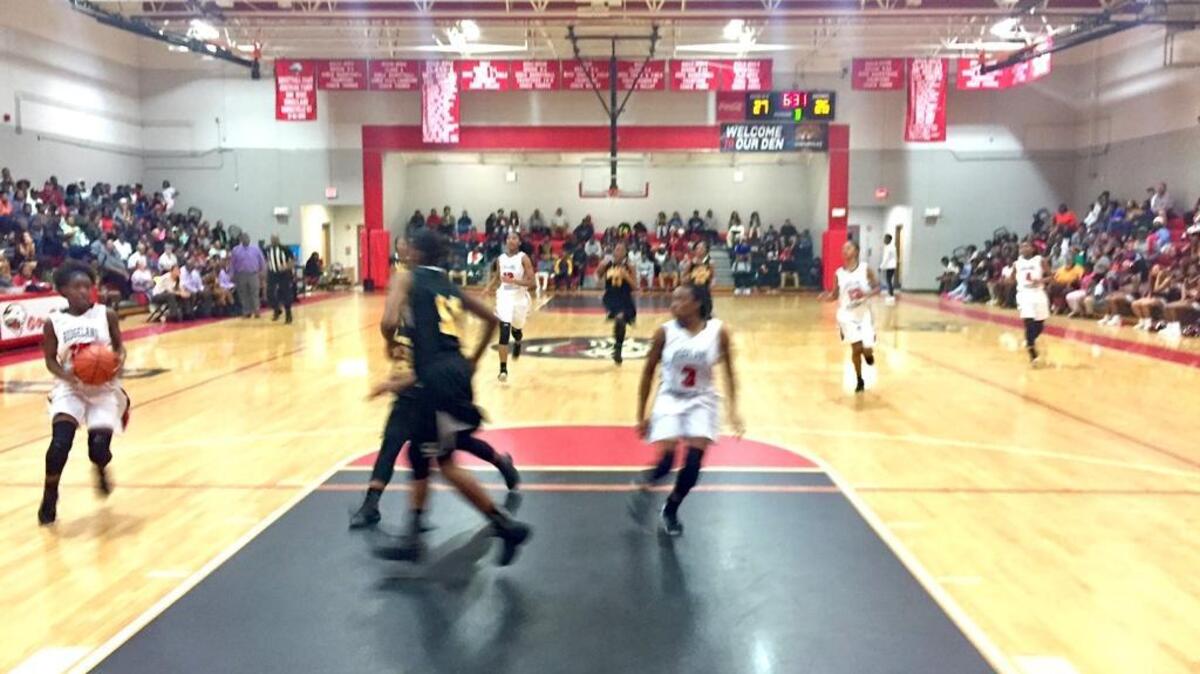 Ridgeland-Hardeeville guard Timothea Green, left, takes a pass from Shania Douglas against Manning in their Class 3A Lower State semifinal playoff game Monday night in Ridgeland. The Jaguars won 56-51.