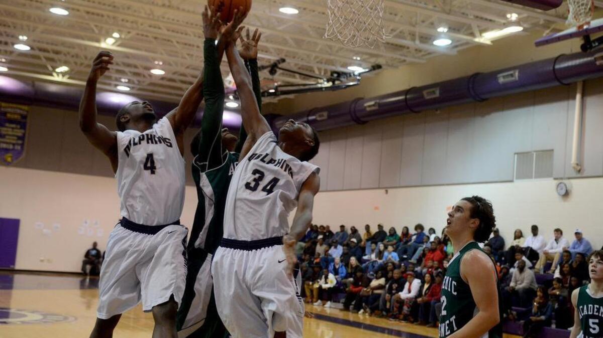 Battery Creek’s Markell Smalls, left, and Timothy Ford, right, jump to retrieve the rebounded ball during their game against Academic Magnet in the one-game playoff Friday, Feb. 12, 2016, at Whale Branch Early College High School.