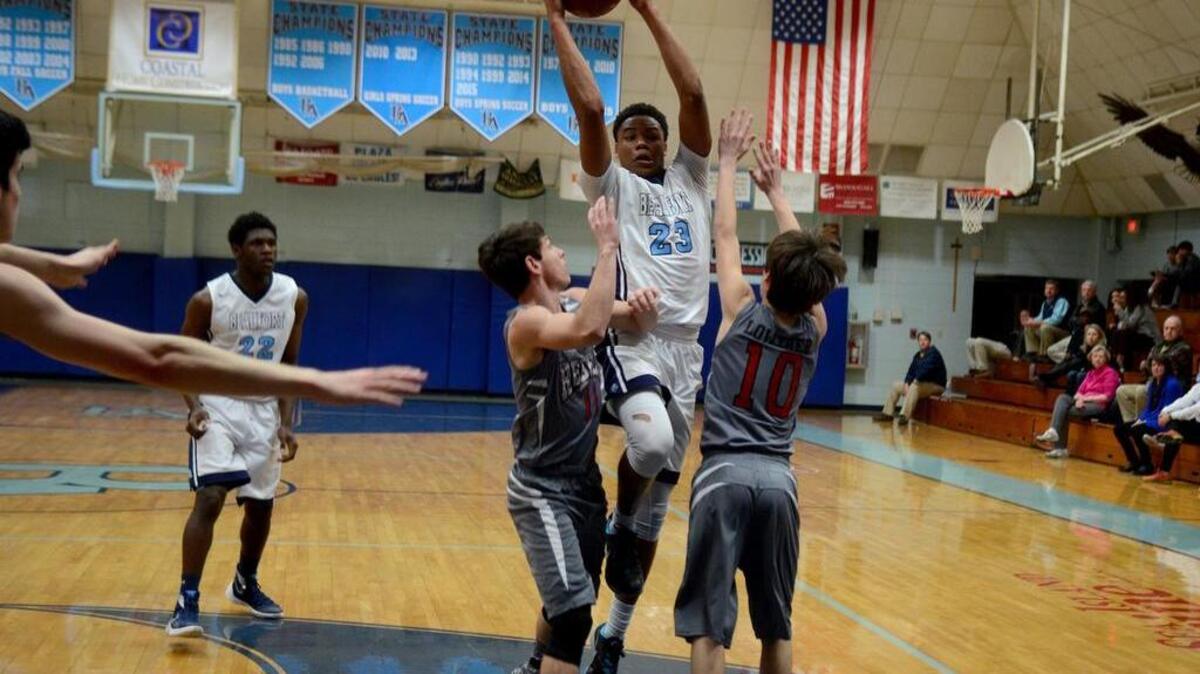 Beaufort Academy’s Kevin Williams, center, tries to pass the ball as Thomas Hayward Academy’s Blake Bannon, left, and Trace Loather try to block him during their game on Thursday, Feb. 11, 2016 at Beaufort Academy on Lady’s Island.