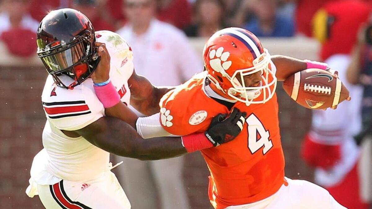 Clemson quarterback Deshaun Watson is pursued by Louisville’s James Sample during an October game in Clemson.